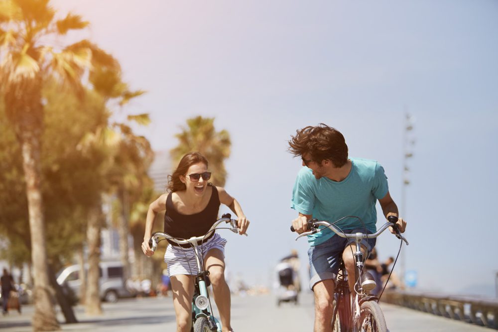 Woman chasing man while riding bicycle